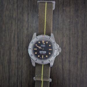 Seiko Silver Watch with Black Face and Green Strap